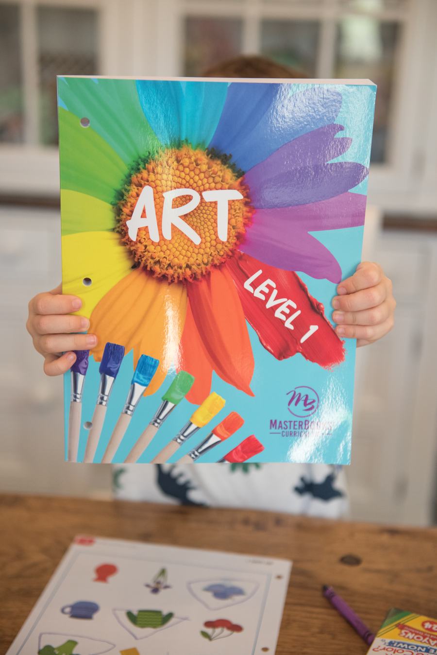 Child holding the Art Level 1 book